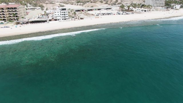 PUNTA GORDA BEACH BCS-2023: Coastal Shoreline with Clear Turquoise Ocean and Beachfront Buildings