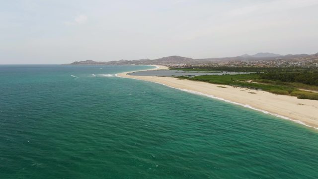 PUERTO LOS CABOS BEACH BCS-2023: Gentle Waves Rolling Along Sandy Shoreline