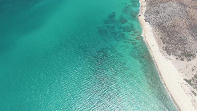Coastal Shoreline with Turquoise Waters and Sandy Beach