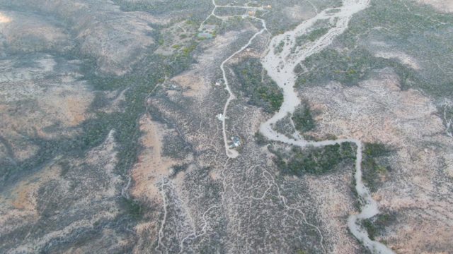 Dry Riverbed with Vehicle Moving Along Waterway