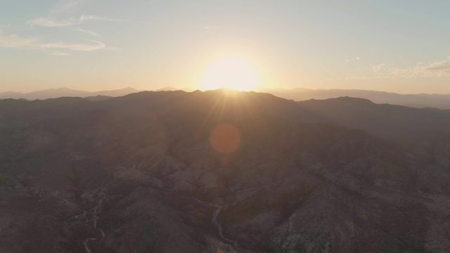 Sun Over Arid Mountain Range