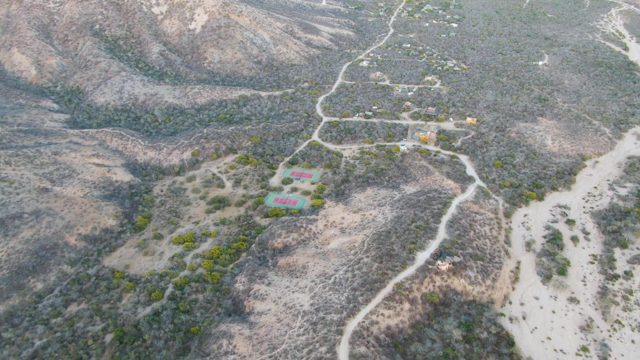 Arid Hillside with Small Buildings and Paths