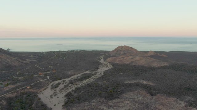 Winding Coastal Road Through Hilly Terrain at Dawn