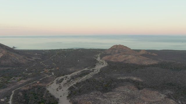 Car Driving on Winding Coastal Mountain Road