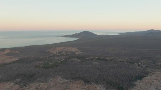 Volcanic Coastline at Dusk with Calm Ocean