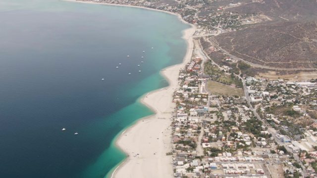 Coastal Town and Sandy Beach Aerial Pan