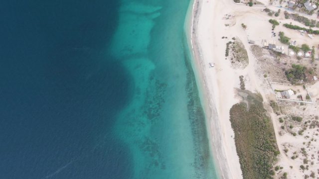 Vehicle Moving Along White Sandy Beach by Clear Ocean