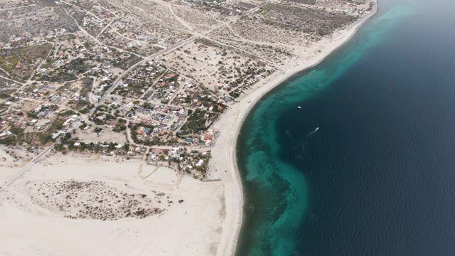 Coastal Settlement with Sandy Beach and Turquoise Water