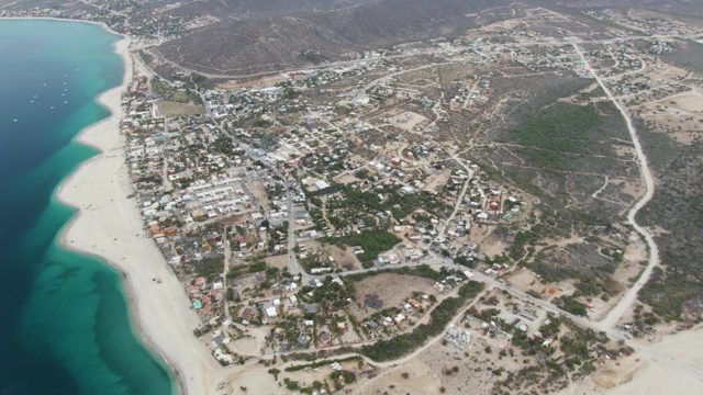 Coastal Town with Beach and Moving Boats