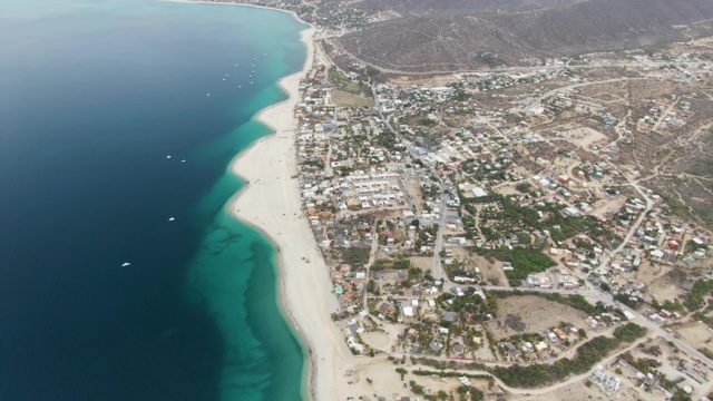 Coastal Town and Moving Boats in Ocean