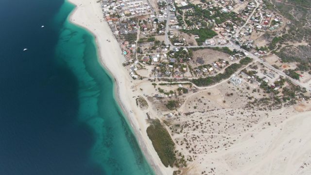 Coastal Town and Sandy Beach with Ocean Boats