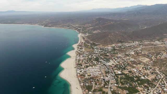 Coastal Town with Shifting Ocean Hues