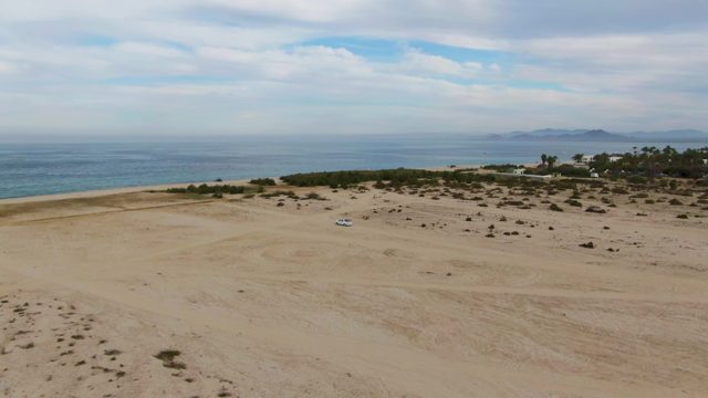 Car Driving on Sandy Beach