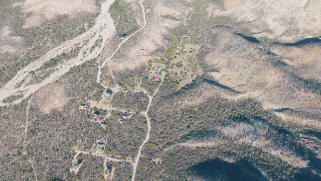 Arid Hills with Scattered Buildings and Dirt Roads