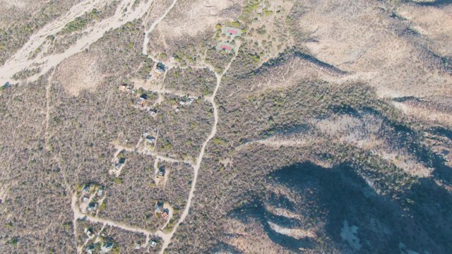 Arid Hills with Scattered Buildings and Dirt Roads
