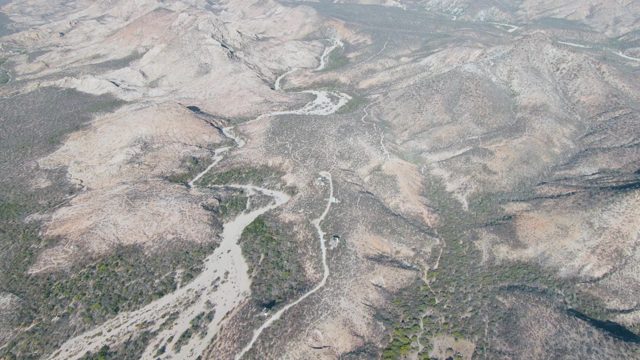 Winding River Flowing Through Mountainous Terrain