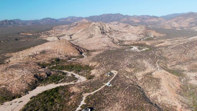 Vehicle Moving Along Winding Desert Road