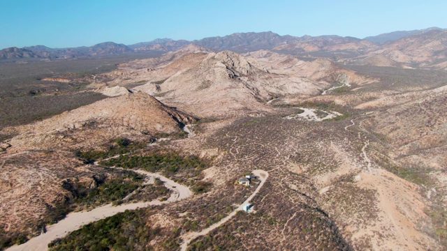Vehicle Traveling on Desert Mountain Road