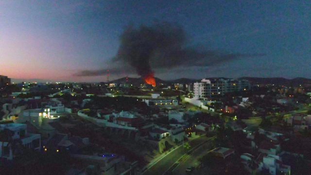 Urban Fire with Thick Black Smoke at Dusk