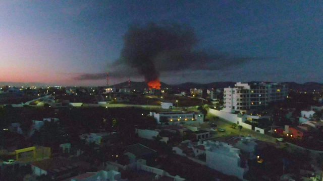 Urban Fire with Thick Black Smoke at Dusk