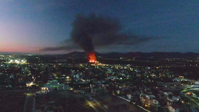 Fire Burning in Urban Area at Dusk