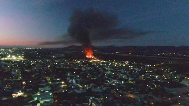 City Fire with Thick Black Smoke at Dusk