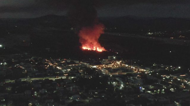 Nighttime Fire and Smoke Over City
