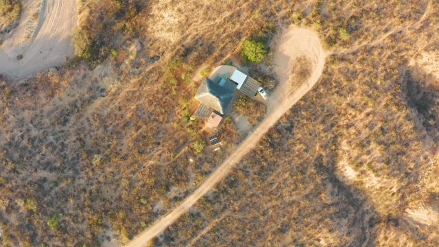 Arid Grassland with Small Structure and Dirt Road