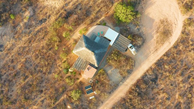 House Roof with Moving Shadow in Dry Landscape