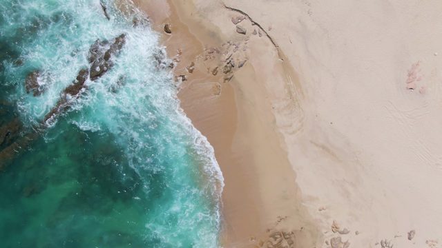 Ocean Waves Crashing on Rocky Sandy Shore