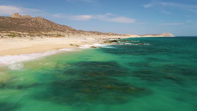 Gentle Waves Lapping Sandy Shore with Turquoise Water