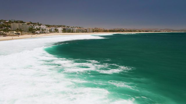 Ocean Wave Advancing Toward Sandy Beach