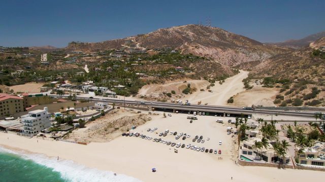 Beachside Highway and Parking Lot with Distant Hills