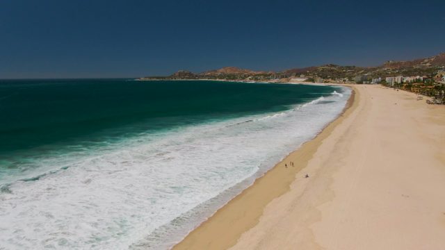 Ocean Waves Rolling Onto Sandy Beach
