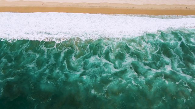 Waves Rolling Toward Sandy Beach