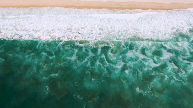 Waves Rolling Onto Sandy Beach From Overhead