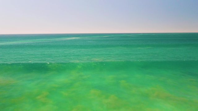 Shallow Ocean Waves Breaking in Clear Turquoise Water