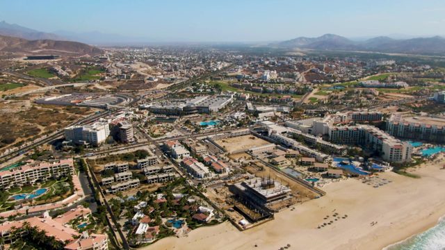 Aerial Pan of Coastal Resort and Beach
