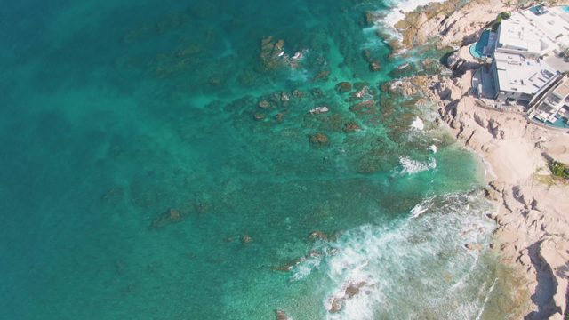 Waves Receding From Rocky Coastal Shore