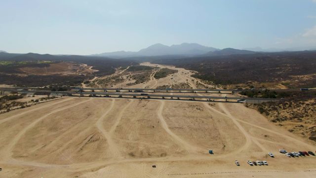 Vehicles Moving on a Road Overpass and Parking Lot