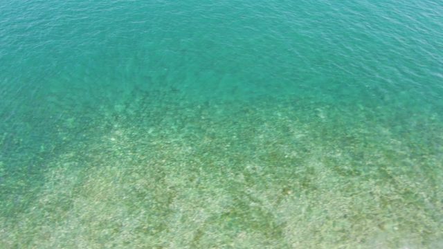 Clear Turquoise Ocean Water Over Sandy Seabed