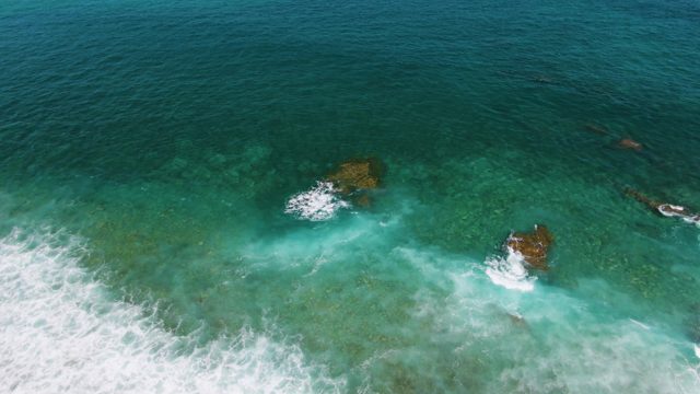 Waves Breaking on Shallow Ocean Rocks