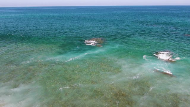 Waves Breaking on Shallow Ocean Rocks