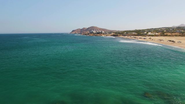 Gentle Waves Rolling Onto Sandy Beach