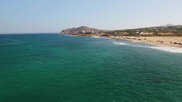 Calm Ocean and Sandy Beach From Aerial View