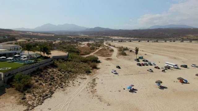 Vehicles Moving in Beach Parking Lot