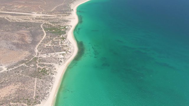 Coastal Shoreline with Arid Terrain and Turquoise Waters