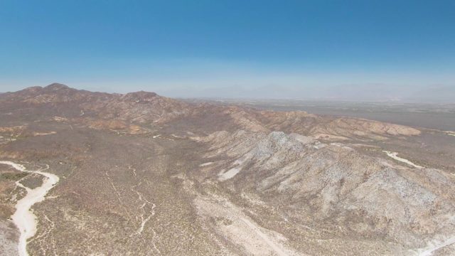 Desert Landscape with Mountain Ranges and Dry Riverbed