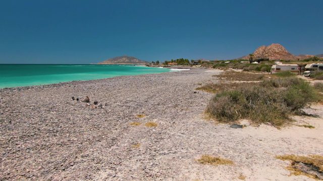 Pebbled Beach with Turquoise Water and Shifting Vantage