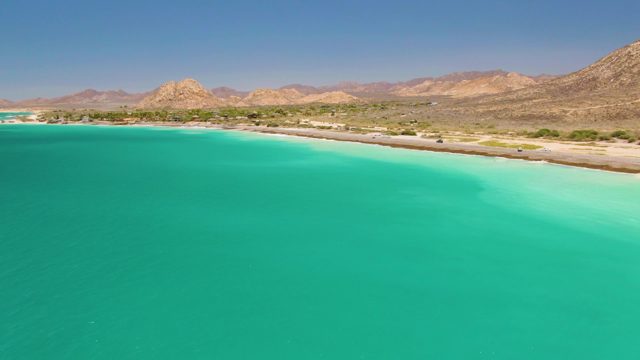 Coastal Road with Vehicles Passing by Turquoise Waters